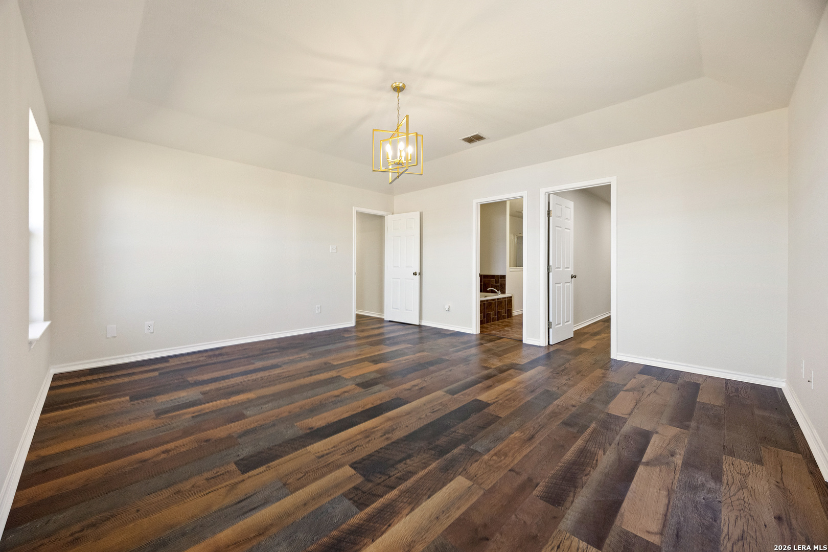 18181 Senior Road Von Ormy, TX 78073 - Photo 22 of 46 wooden floor in an empty room with a window