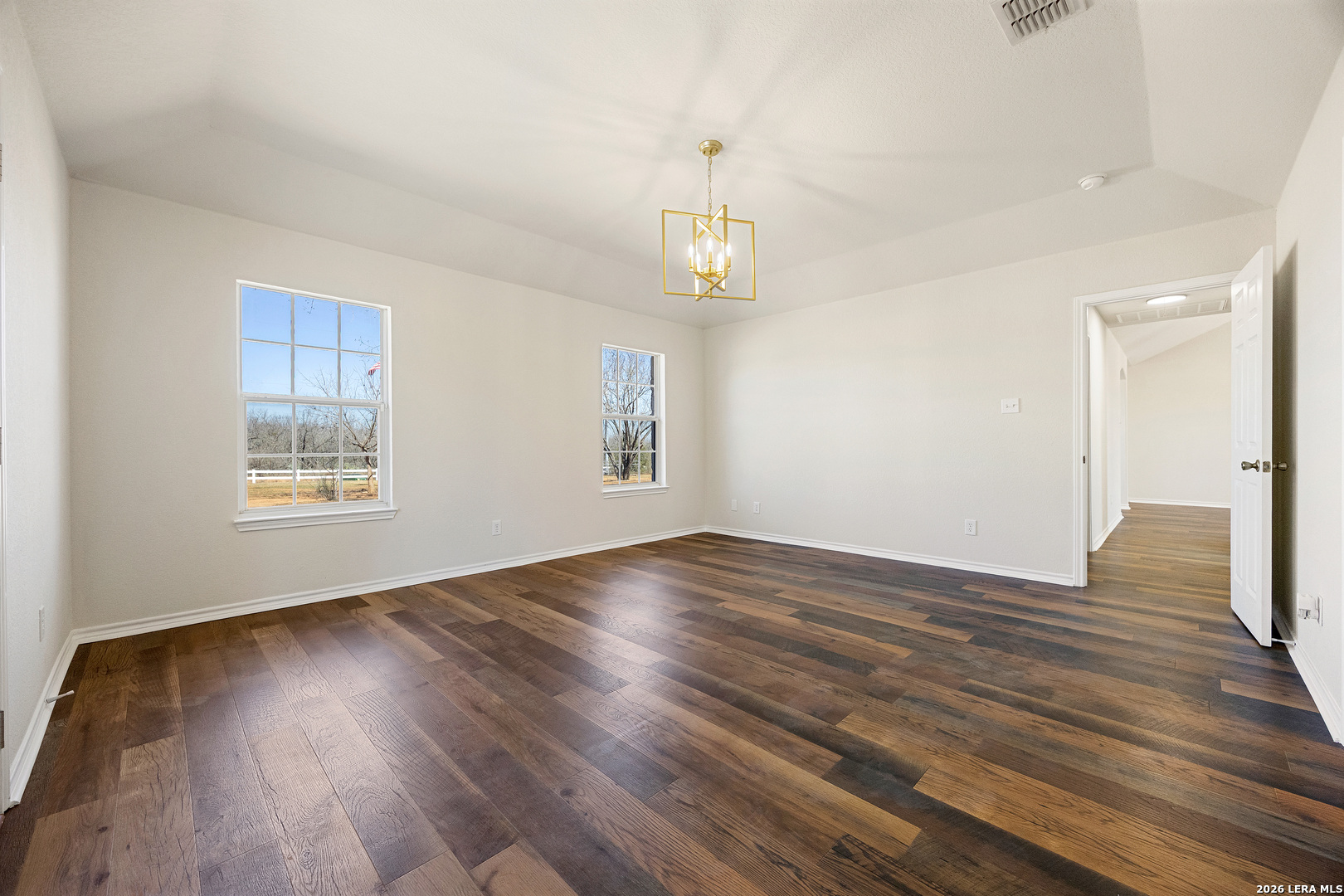18181 Senior Road Von Ormy, TX 78073 - Photo 23 of 46 wooden floor in an empty room with a window