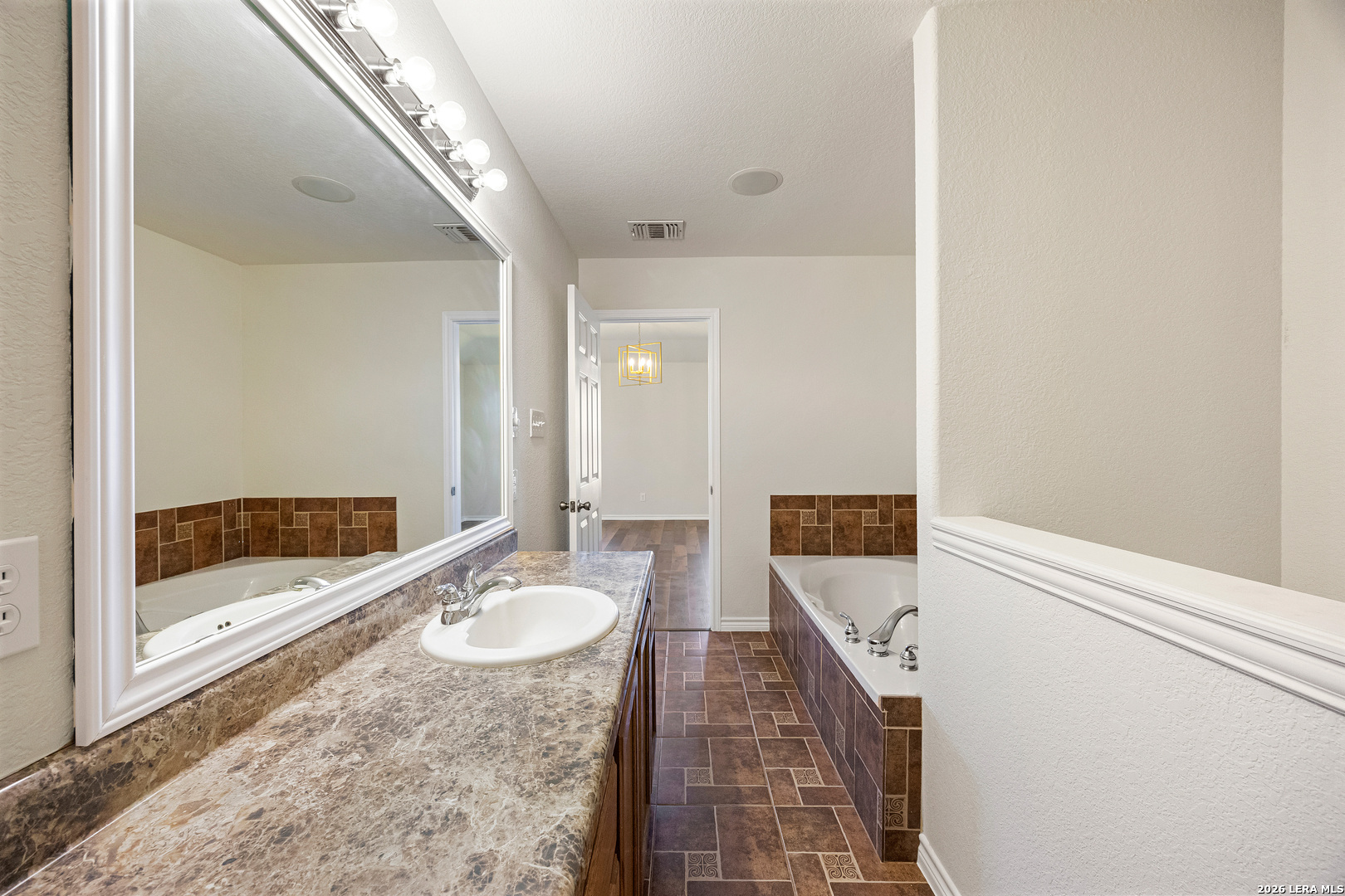 18181 Senior Road Von Ormy, TX 78073 - Photo 26 of 46 a bathroom with a sink and a mirror