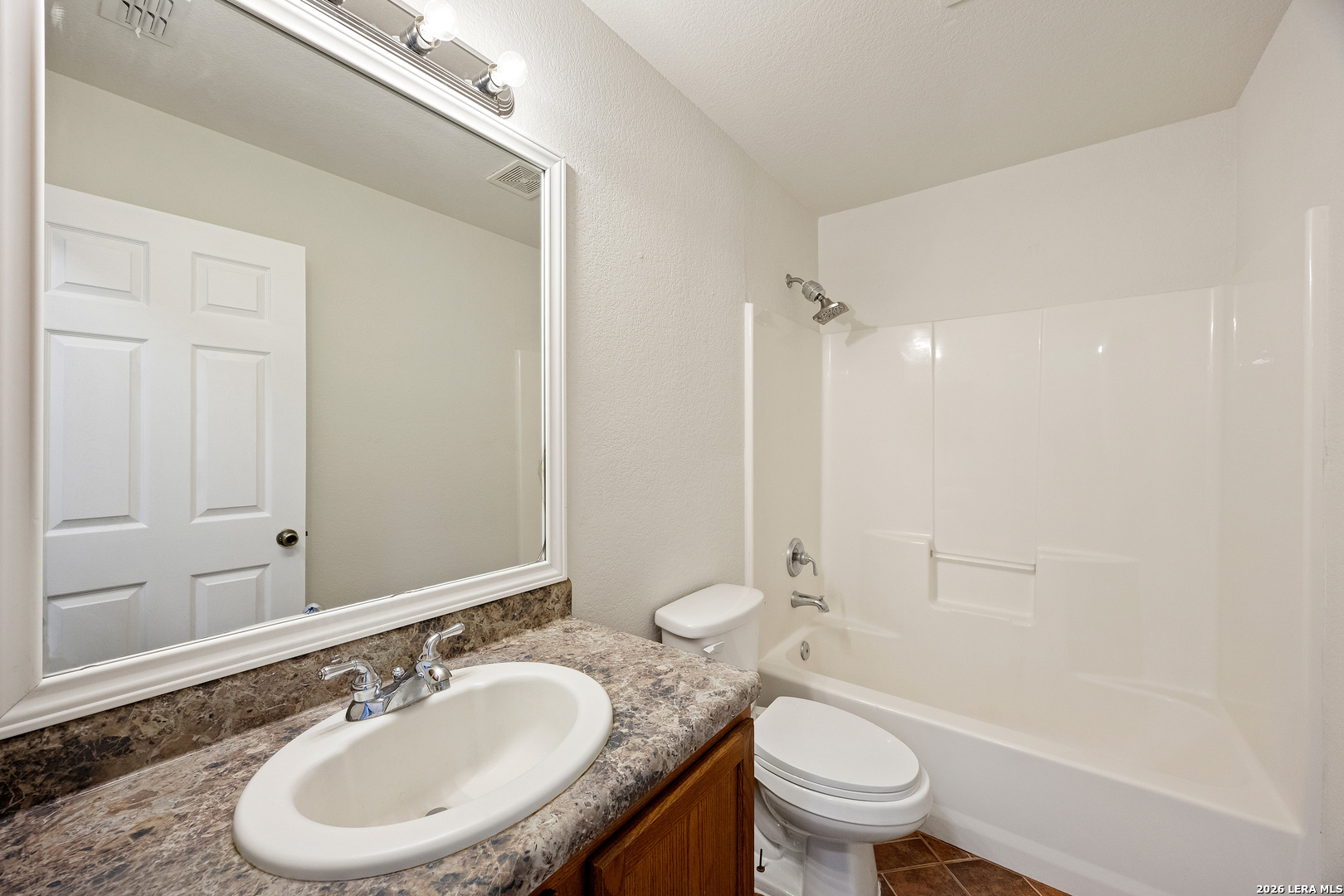 18181 Senior Road Von Ormy, TX 78073 - Photo 28 of 46 a bathroom with a sink a toilet and a mirror