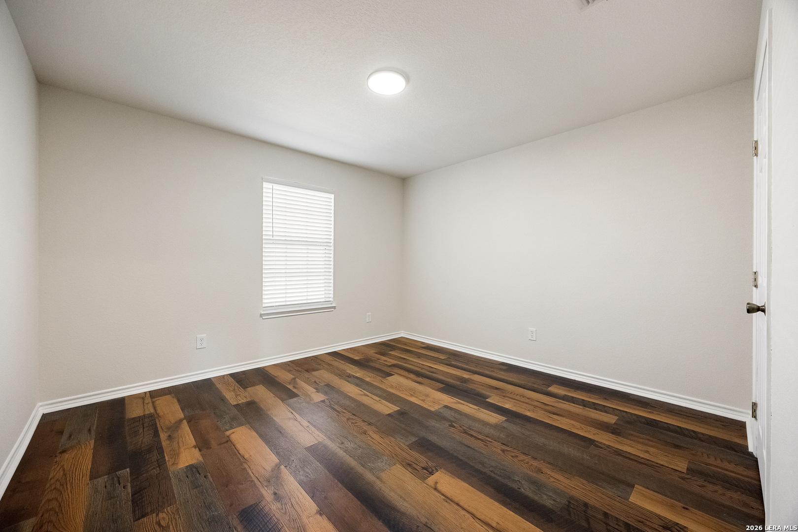 18181 Senior Road Von Ormy, TX 78073 - Photo 31 of 46 a view of empty room with wooden floor