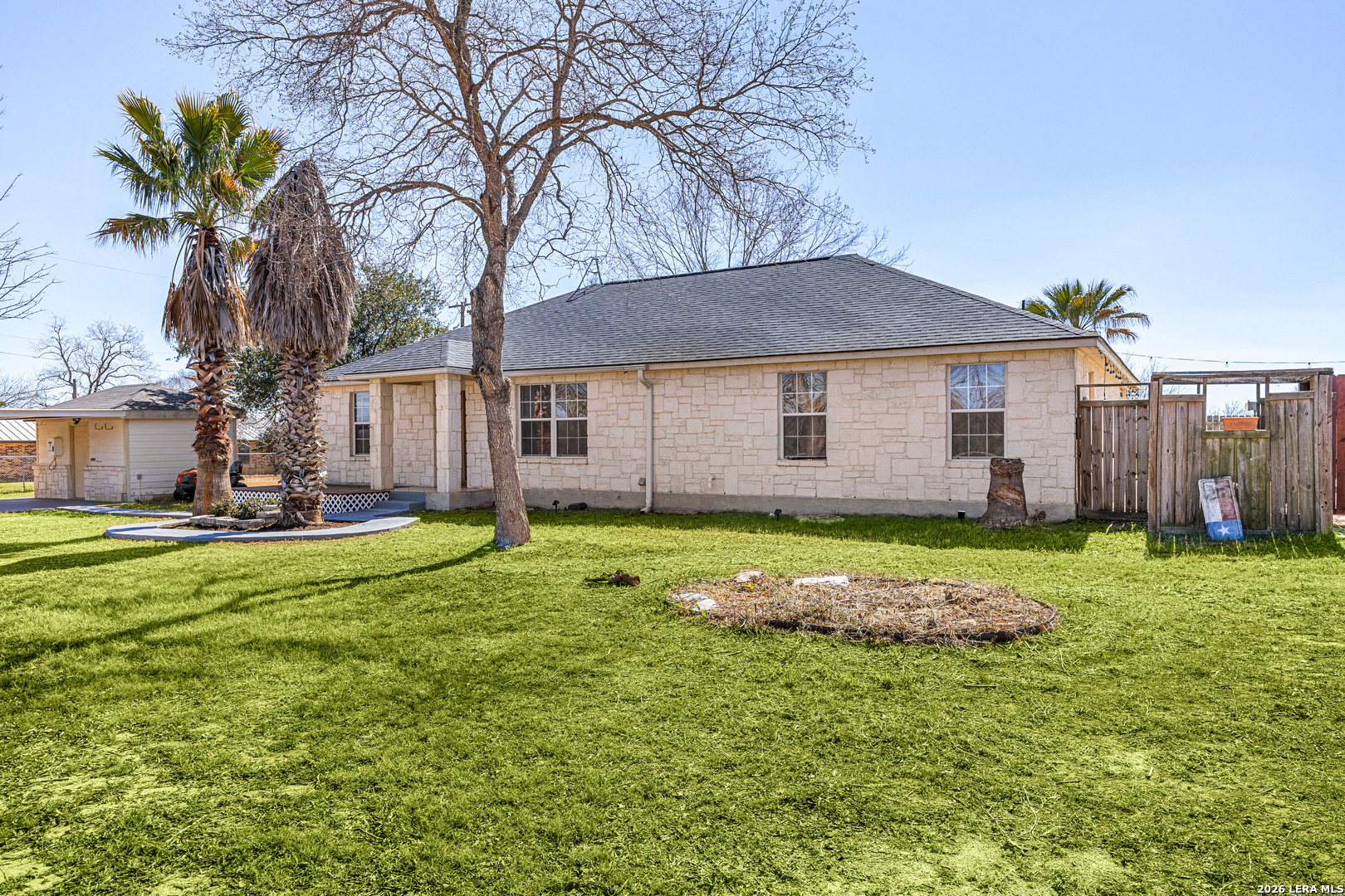18181 Senior Road Von Ormy, TX 78073 - Photo 4 of 46 a backyard of a house with table and chairs plants and large tree