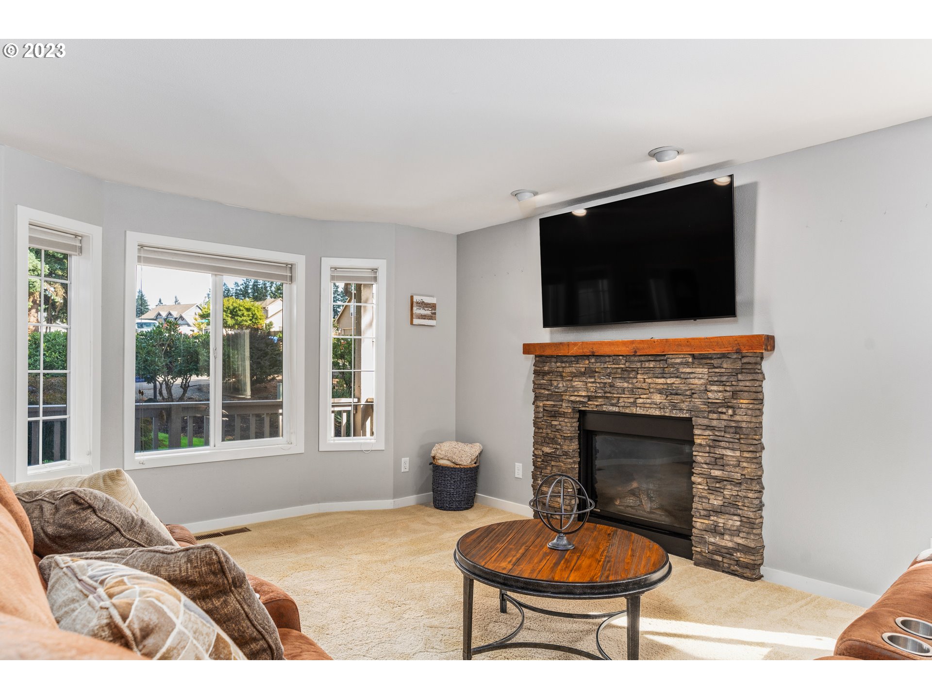 5963 Timber Ridge Drive Southeast Salem, OR 97317 - Photo 16 of 39 a living room with furniture a fireplace and a flat screen tv