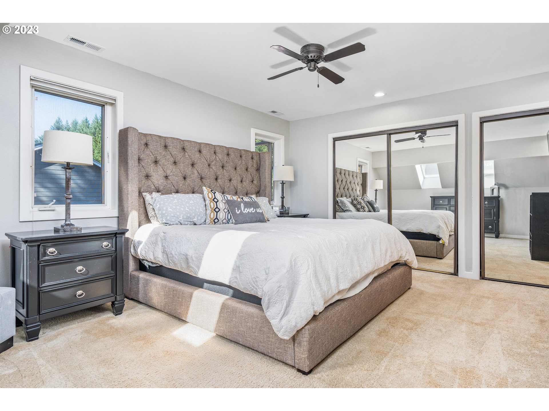 5963 Timber Ridge Drive Southeast Salem, OR 97317 - Photo 28 of 39 a bedroom with a large bed and a chandelier