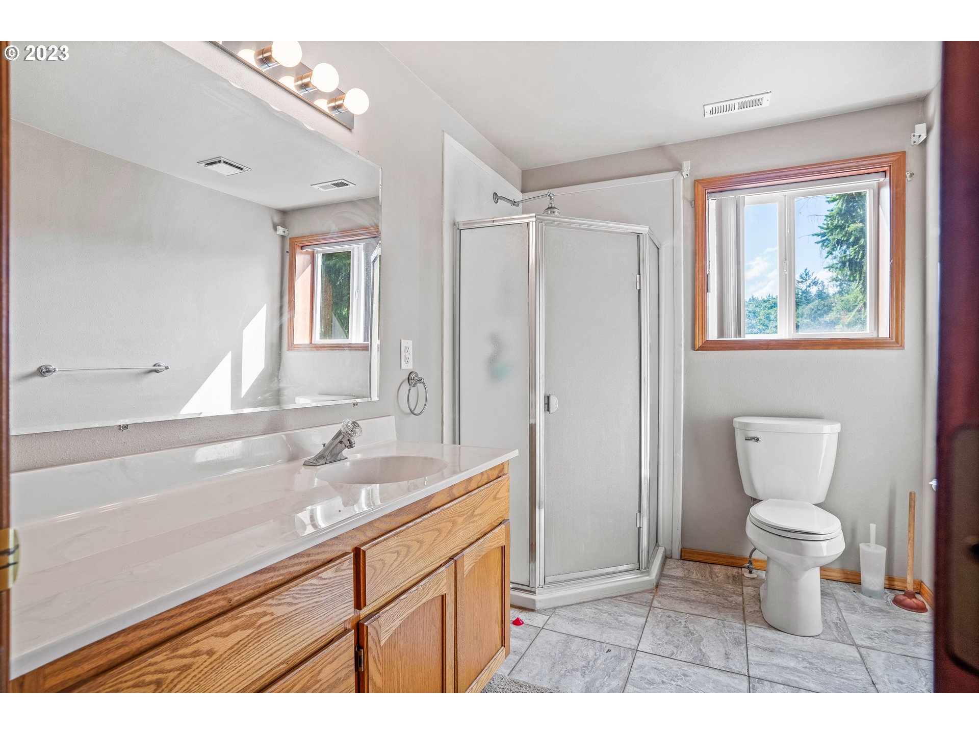 5963 Timber Ridge Drive Southeast Salem, OR 97317 - Photo 36 of 39 a bathroom with a sink toilet a mirror and shower