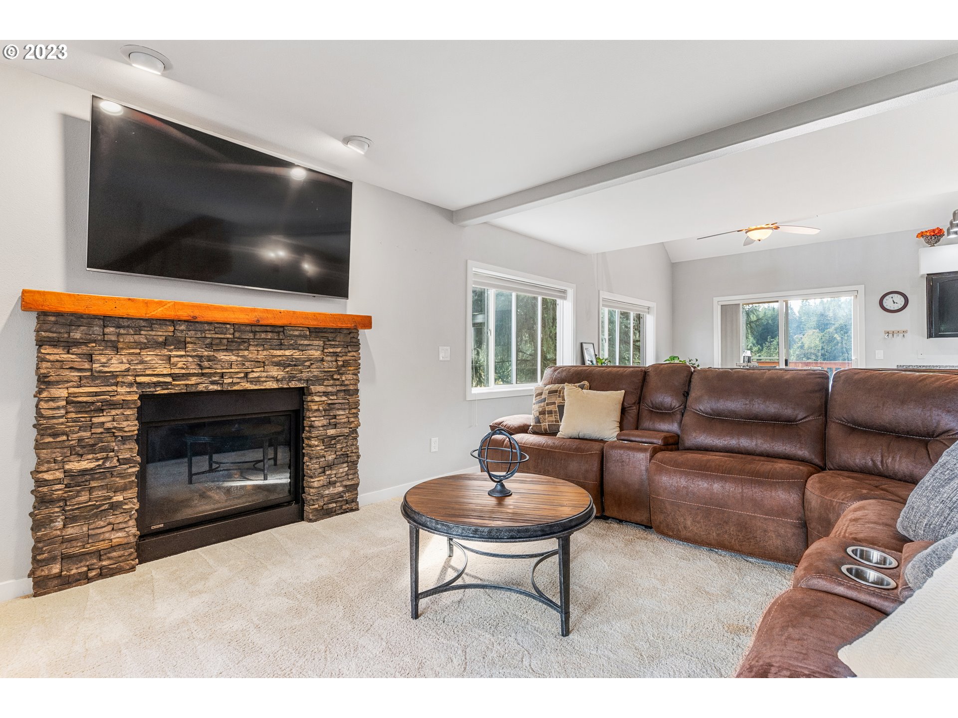 5963 Timber Ridge Drive Southeast Salem, OR 97317 - Photo 10 of 39 a living room with furniture a flat screen tv and a fireplace