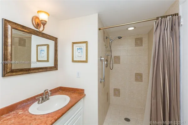 a bathroom with a toilet mirror and vanity