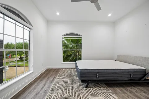 an empty room with wooden floor cabinet and a flat screen tv