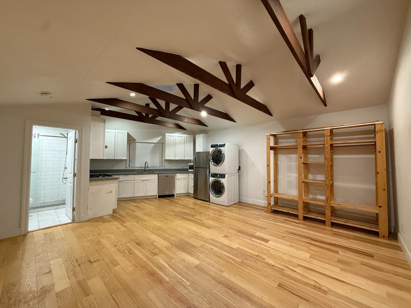 a view of a kitchen with a sink and a refrigerator