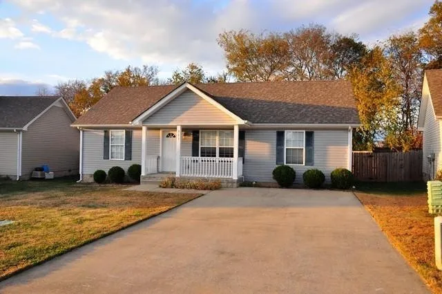 a front view of a house with a yard and porch
