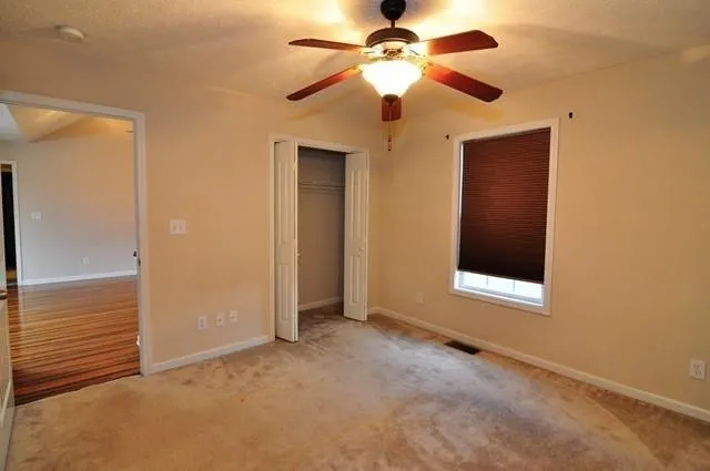 a view of an empty room with a ceiling fan