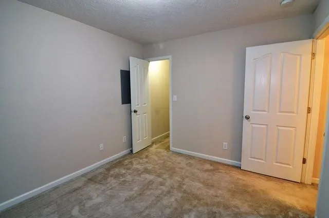 a view of an empty room with closet area