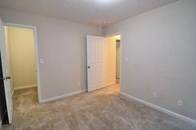 an empty room with closet and a window