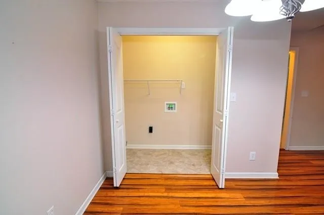 a view of a room with wooden floor and a window