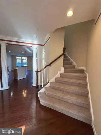 a view of entryway and hall with wooden floor