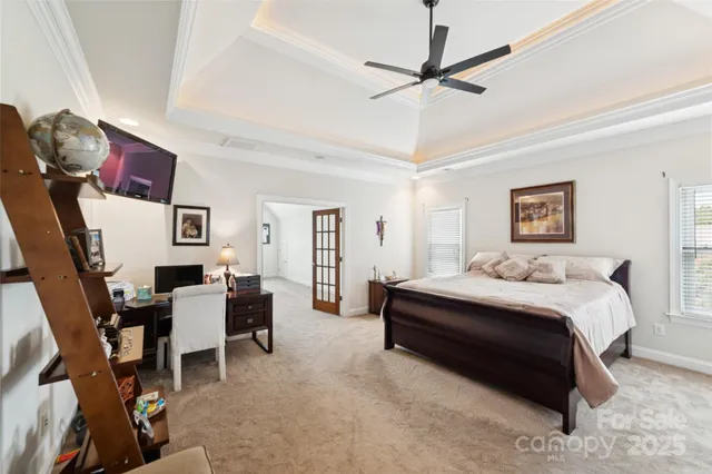 a spacious bedroom with a bed and a chair