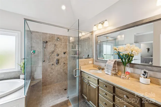 a bathroom with a tub sink and shower