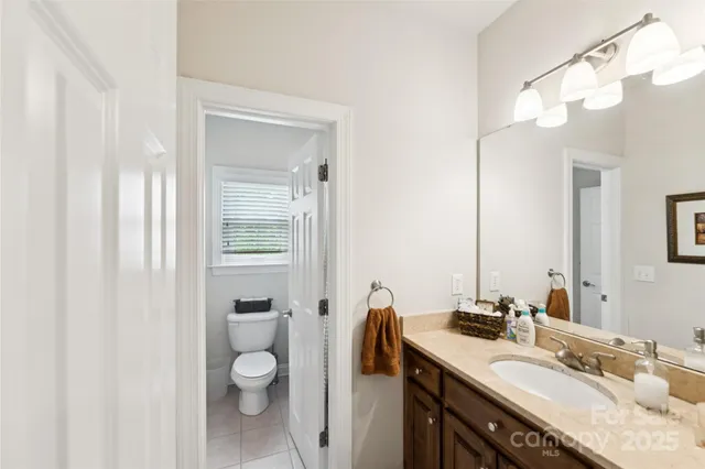 a bedroom with two beds and a chandelier