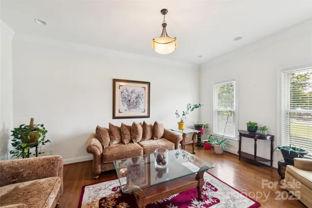 a living room with furniture and a chandelier