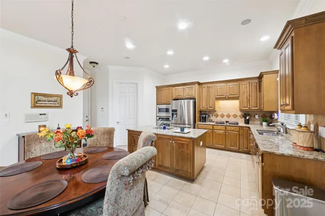 a large kitchen with a table and chairs