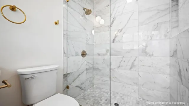 a white toilet sitting next to a bathroom sink