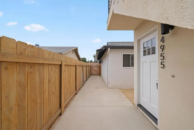 a view of a house with a wooden fence