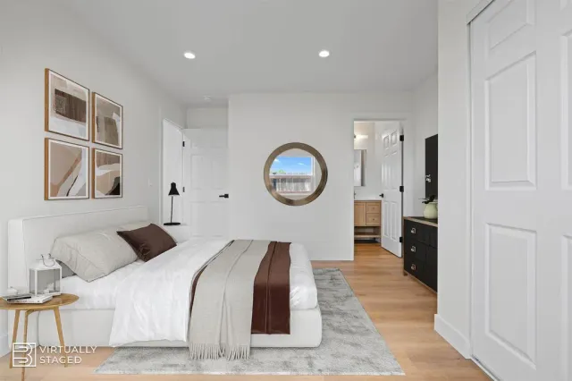 a bedroom with bed and a large mirror