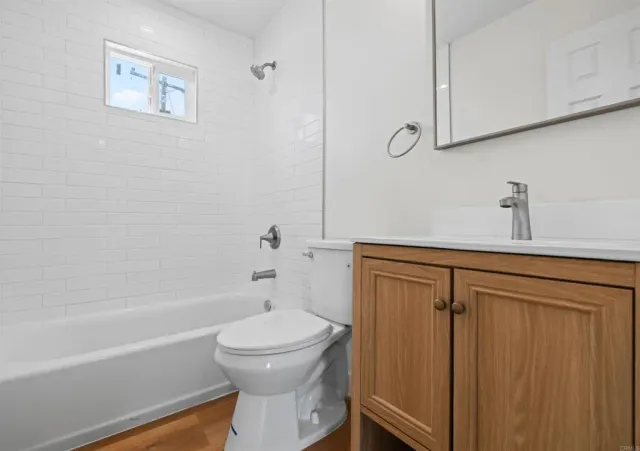 a bathroom with a toilet a sink and bathtub