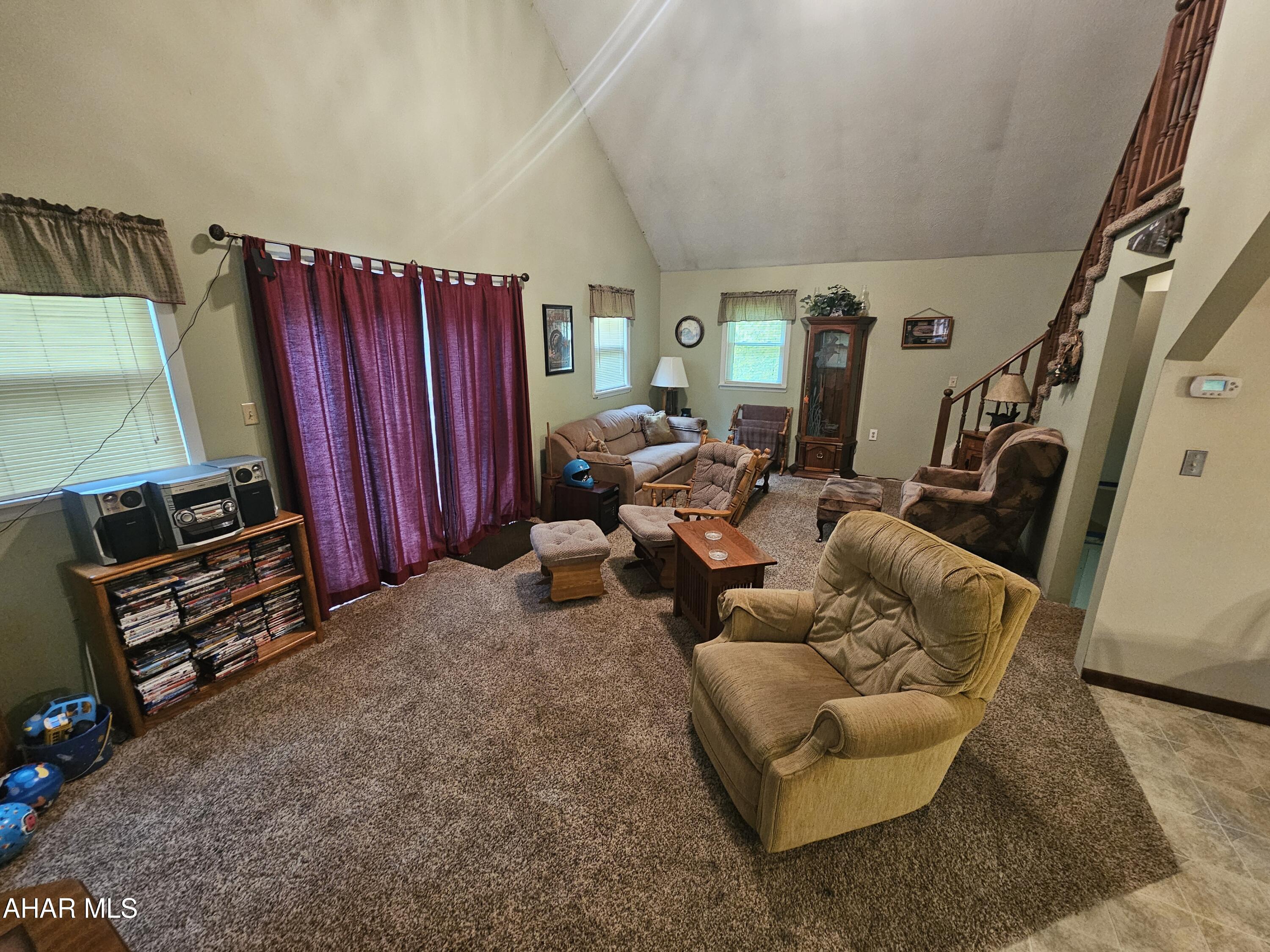 207 Kendrick Lane Flinton, PA 16640 - Photo 19 of 30 a living room with furniture a fireplace and a flat screen tv