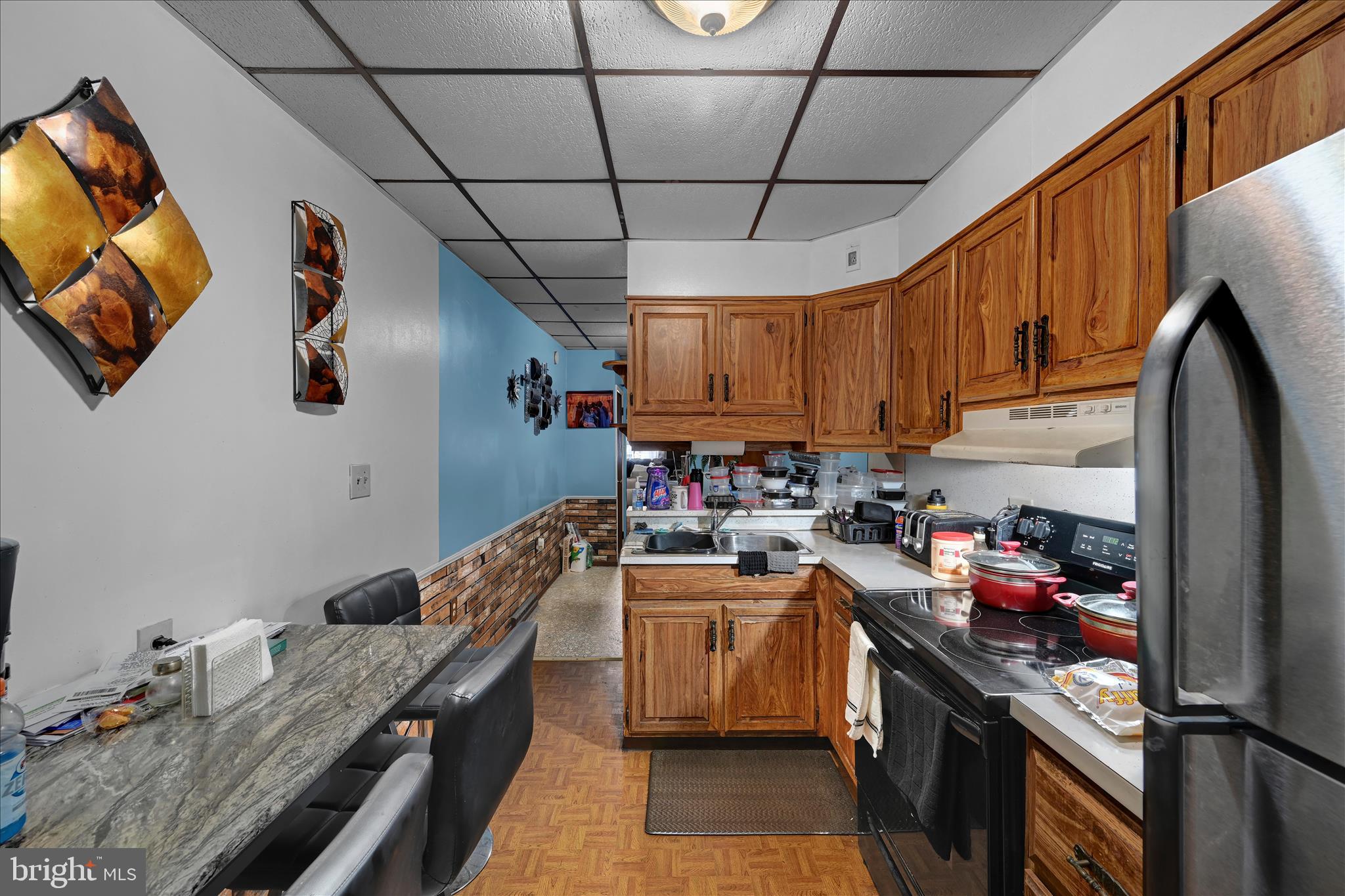 936 Pike Street Reading, PA 19604 - Photo 13 of 24 a kitchen with stainless steel appliances granite countertop a sink stove and refrigerator
