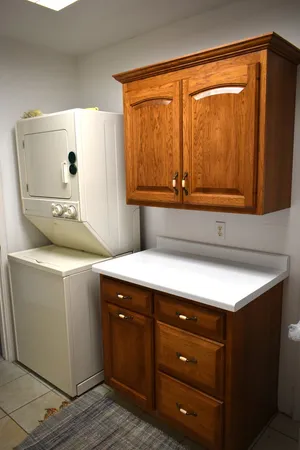 a view of a kitchen with a sink and a refrigerator