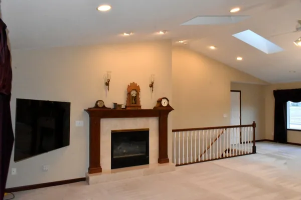 a view of a living room with a fireplace and a large window