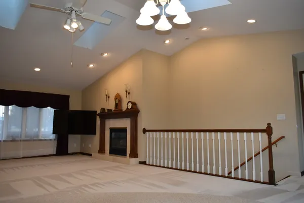 a large kitchen with a window and chandelier