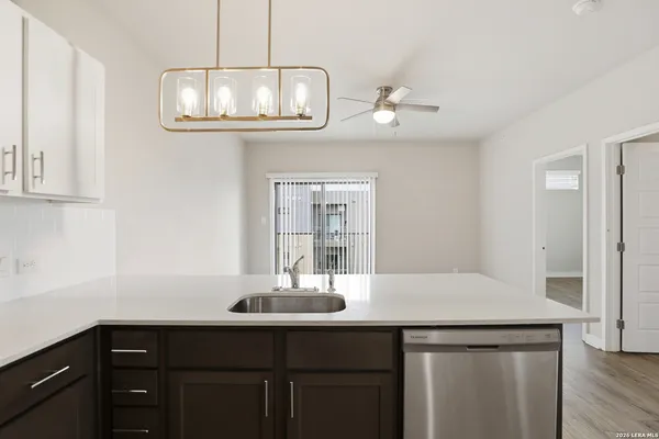 a kitchen with a sink and chandelier