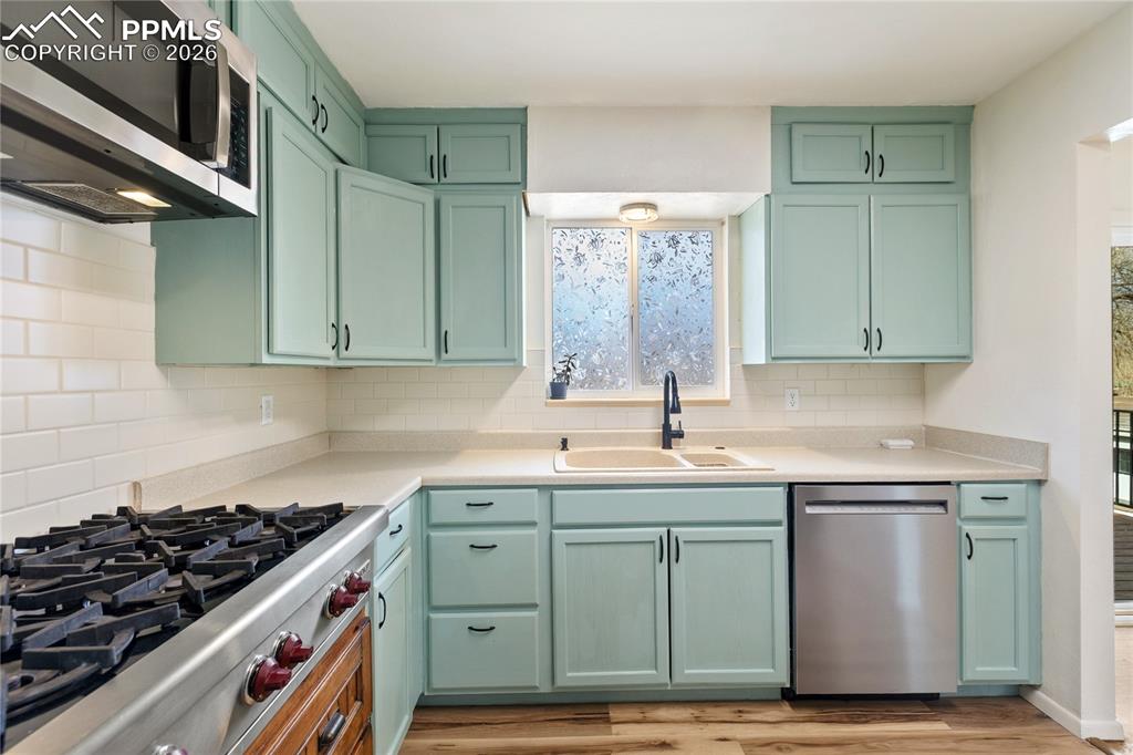528 Rowe Lane Colorado Springs, CO 80911 - Photo 12 of 38 a kitchen with stainless steel appliances a stove and cabinets