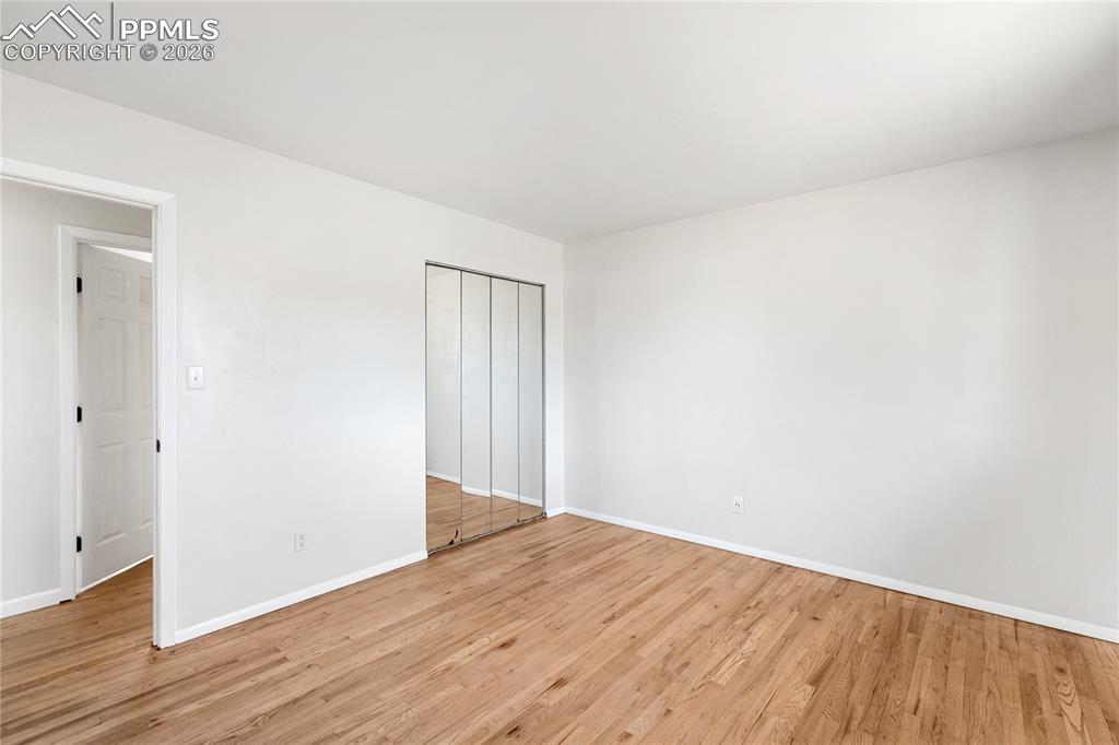 528 Rowe Lane Colorado Springs, CO 80911 - Photo 15 of 38 a view of an empty room with wooden floor