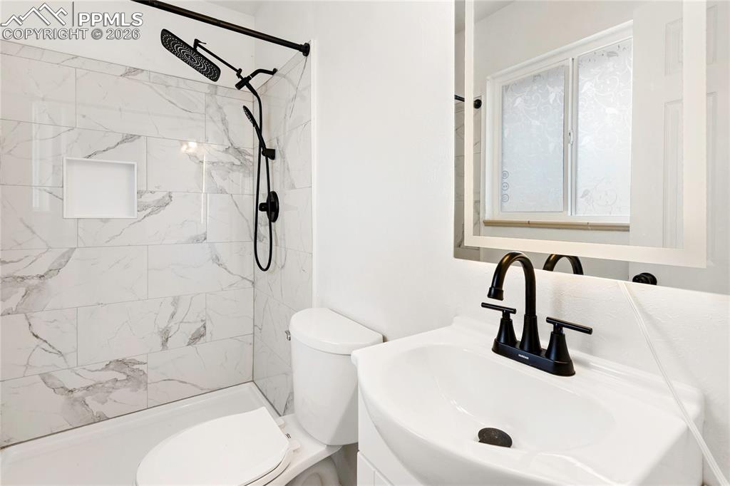 528 Rowe Lane Colorado Springs, CO 80911 - Photo 17 of 38 a bathroom with a sink a toilet and shower