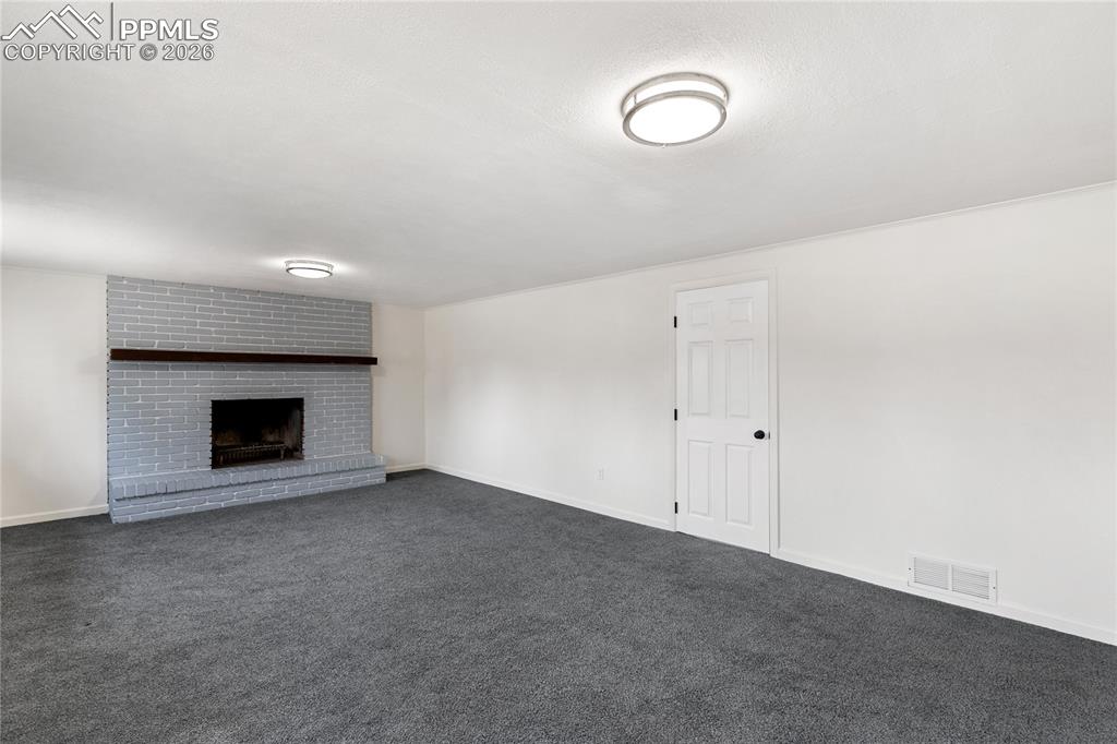 528 Rowe Lane Colorado Springs, CO 80911 - Photo 23 of 38 a view of an empty room with a fireplace