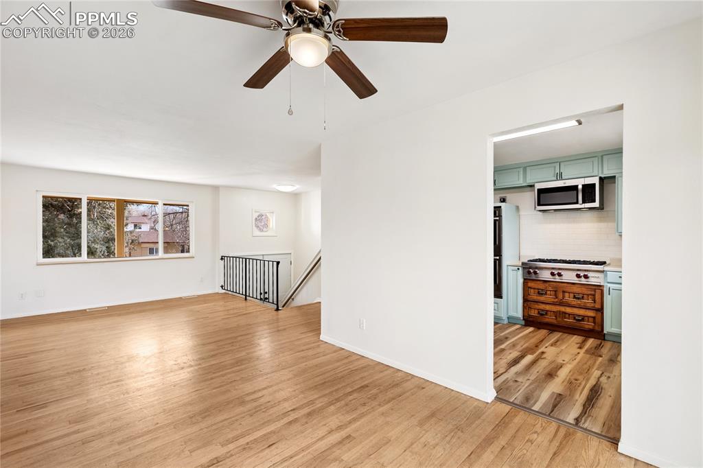 528 Rowe Lane Colorado Springs, CO 80911 - Photo 4 of 38 a view of empty room with wooden floor and window