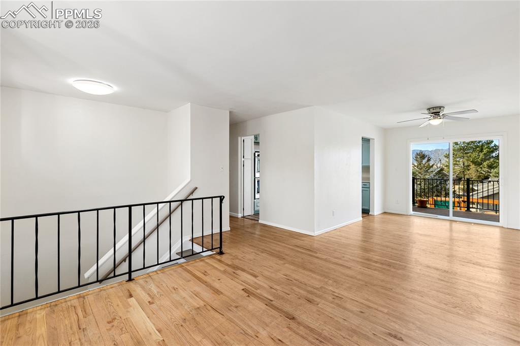 528 Rowe Lane Colorado Springs, CO 80911 - Photo 6 of 38 a view of an empty room with wooden floor and a window