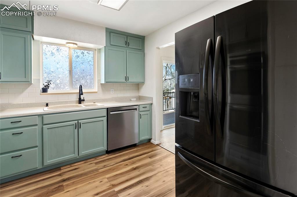528 Rowe Lane Colorado Springs, CO 80911 - Photo 10 of 38 a kitchen with a refrigerator and a sink