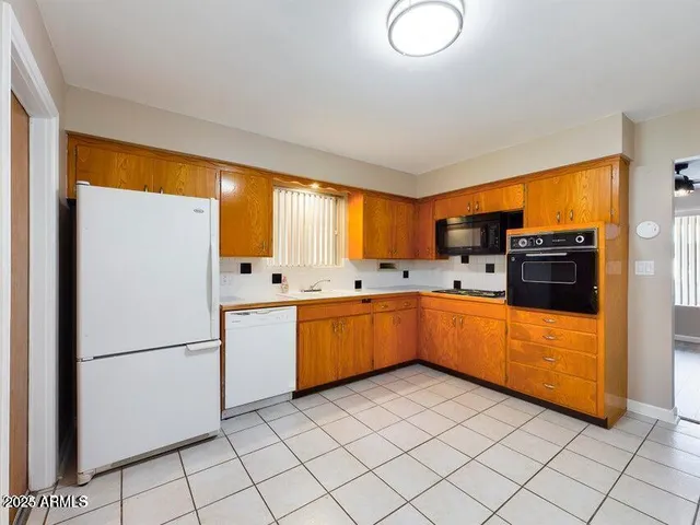 a kitchen with a refrigerator and a sink