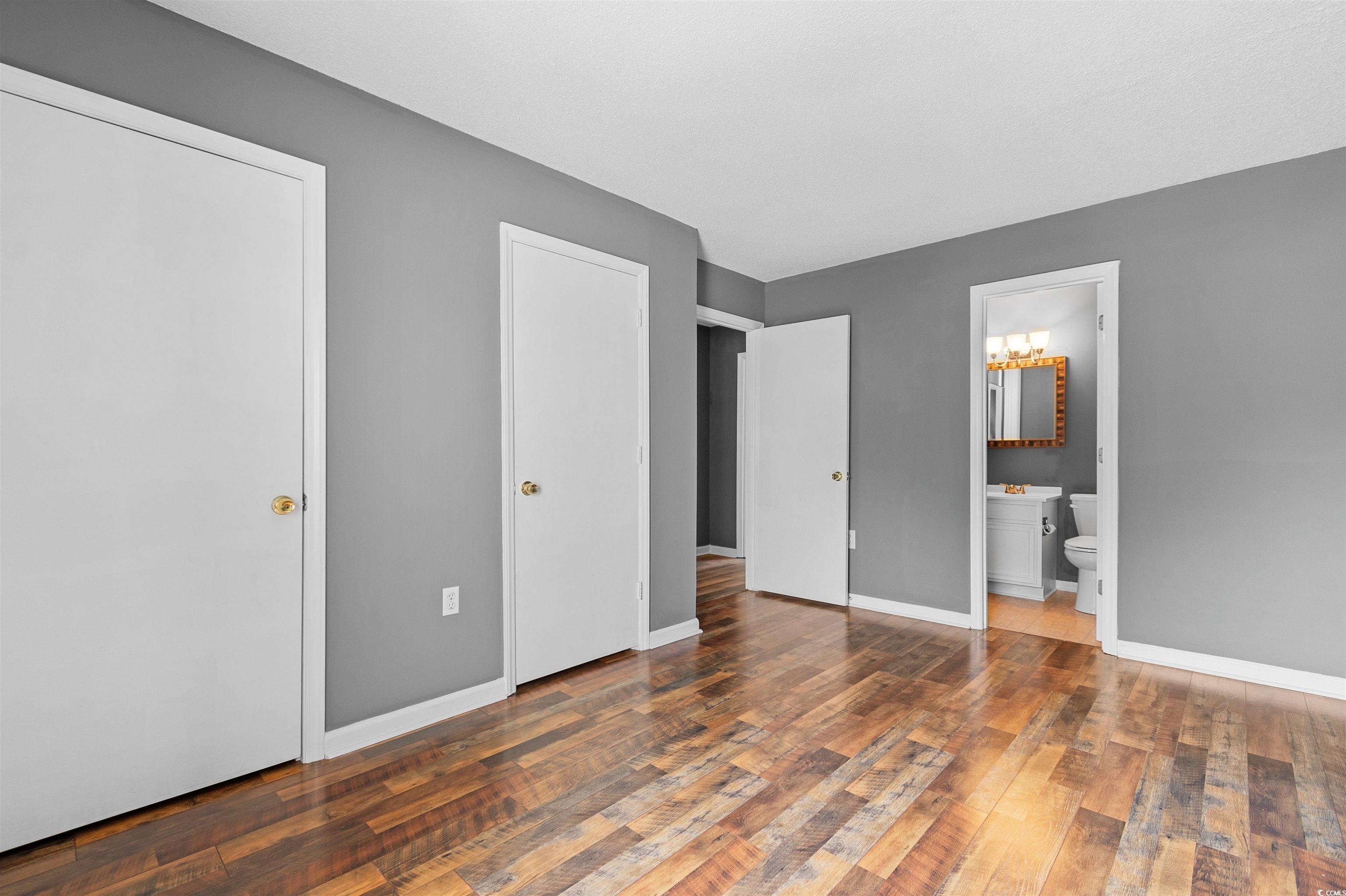1012 Possum Trot Road, Unit A7 North Myrtle Beach, SC 29582 - Photo 13 of 30 Bathroom with vanity, toilet, and hardwood / wood-