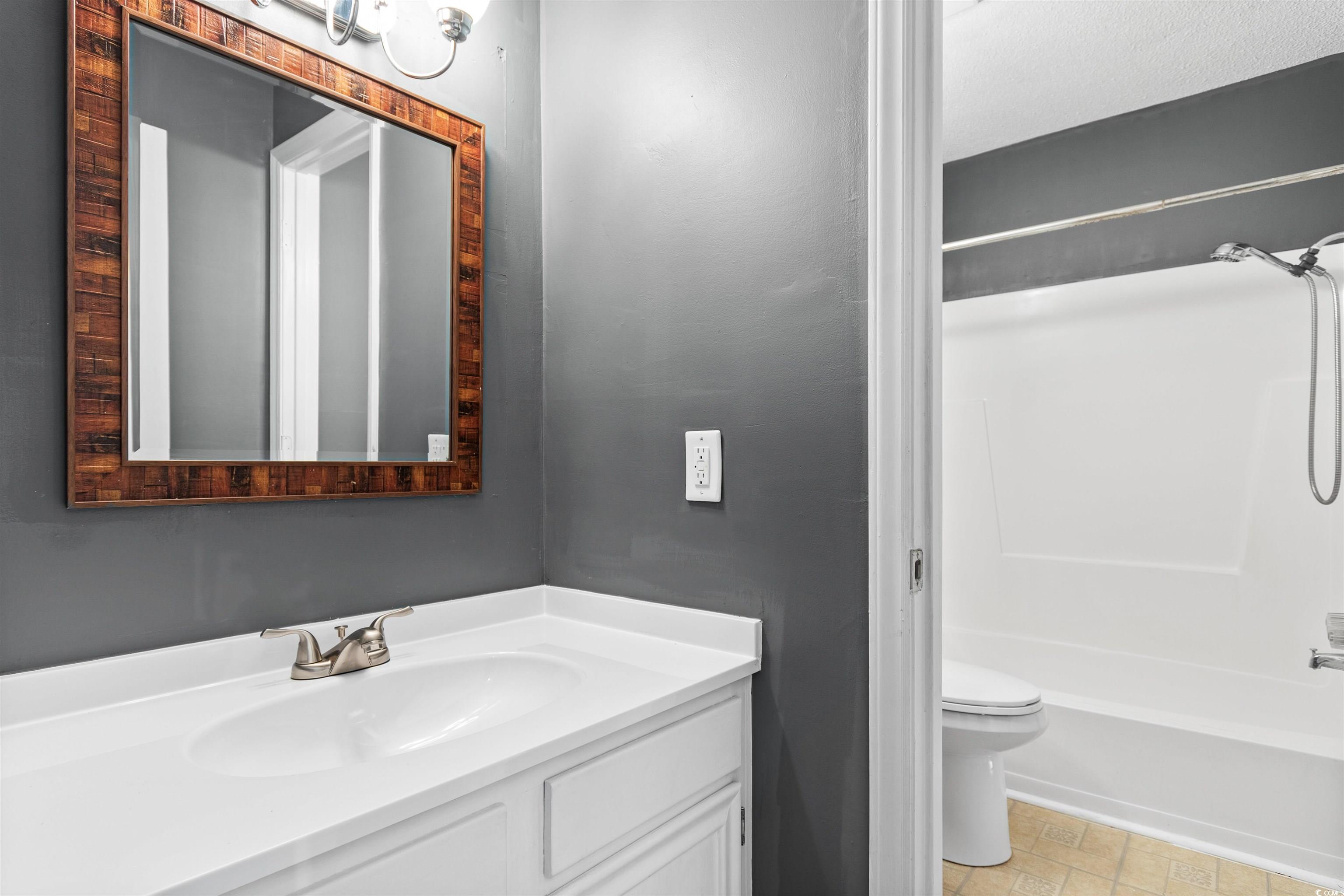1012 Possum Trot Road, Unit A7 North Myrtle Beach, SC 29582 - Photo 14 of 30 Unfurnished bedroom featuring two closets, high va