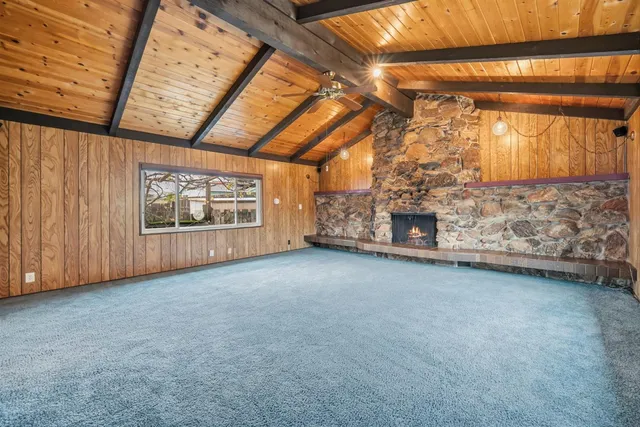 a view of an empty room with a fireplace