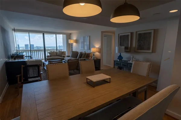 a kitchen with a table chairs refrigerator and couch