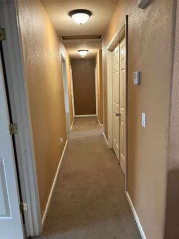 a spacious bedroom with a bed and a flat screen tv