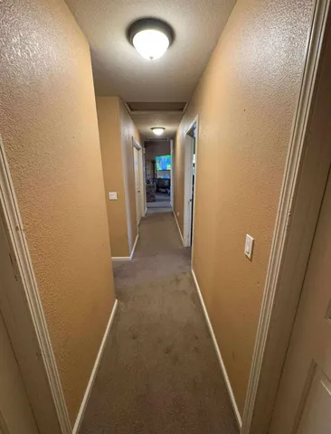 a view of a porch with furniture and a yard