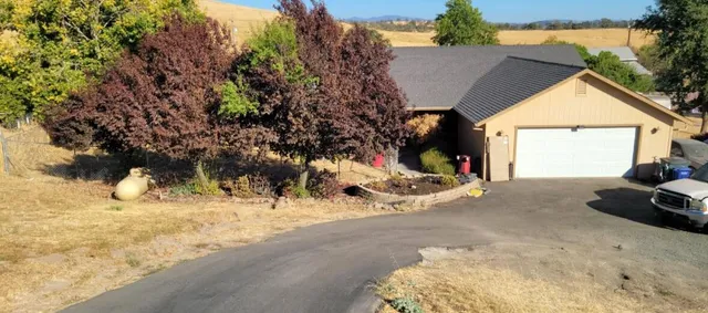 a bedroom with a bed a dresser and flat screen tv