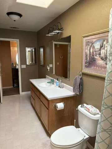 a bedroom with bed and a chandelier